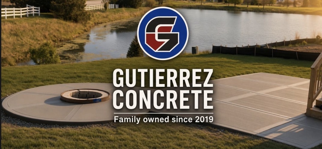 Freshly poured circular concrete fire pit pad connected to a scored concrete patio beside a pond
